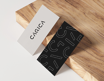 CAGICA business cards on a wood surface